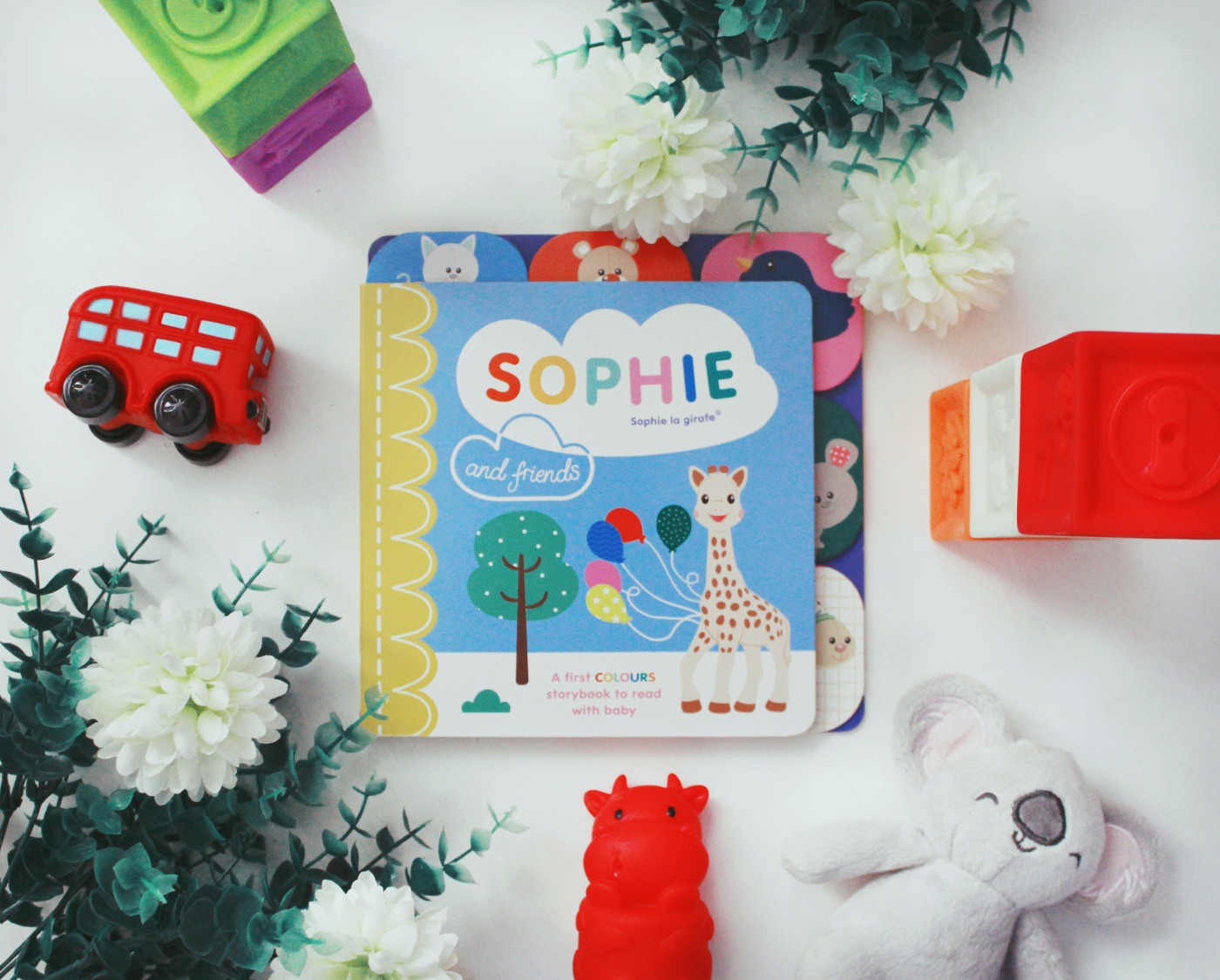 A photo of the book Sophie la girafe, surrounded by childrens toys